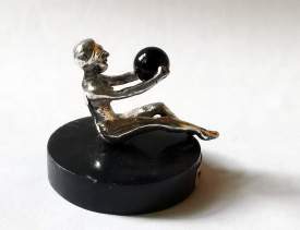 silver figurine with onyx ball