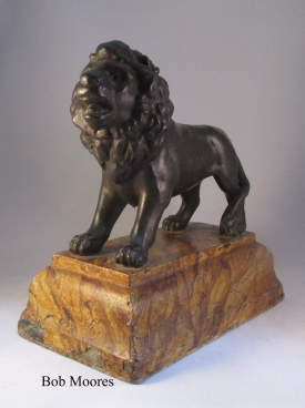 19th century cast iron figure of a lion on faux marble base   | 19th Century pottery